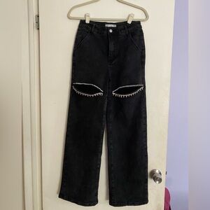 Black wide leg straight jeans with openings at thighs
